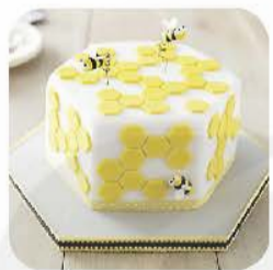 A cake with bees on top

Description automatically generated