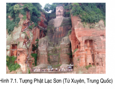 A large statue of a person in a cliff with Leshan Giant Buddha in the background

Description automatically generated