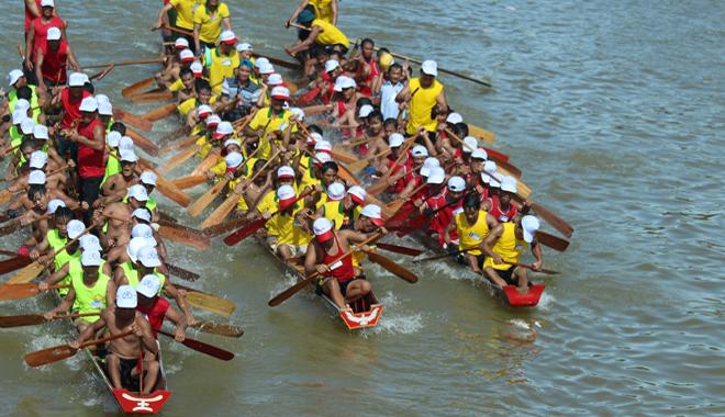 A group of people rowing a boat

Description automatically generated